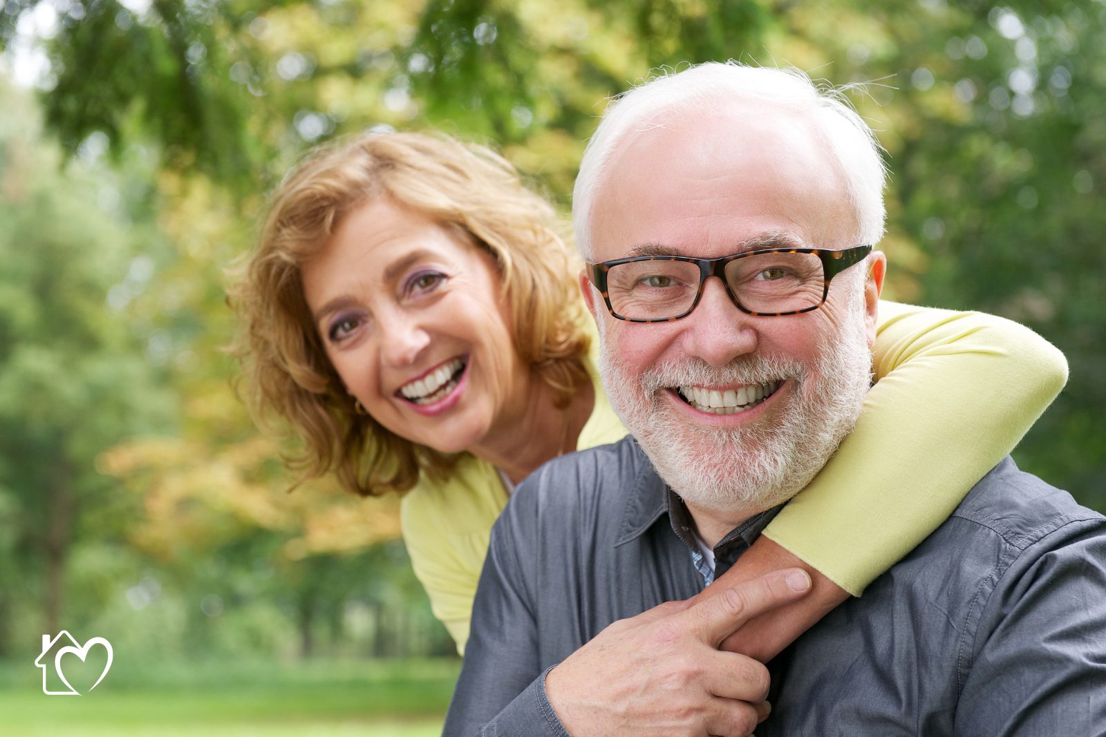 An older man and his adult daughter reviewing a care plan together at home