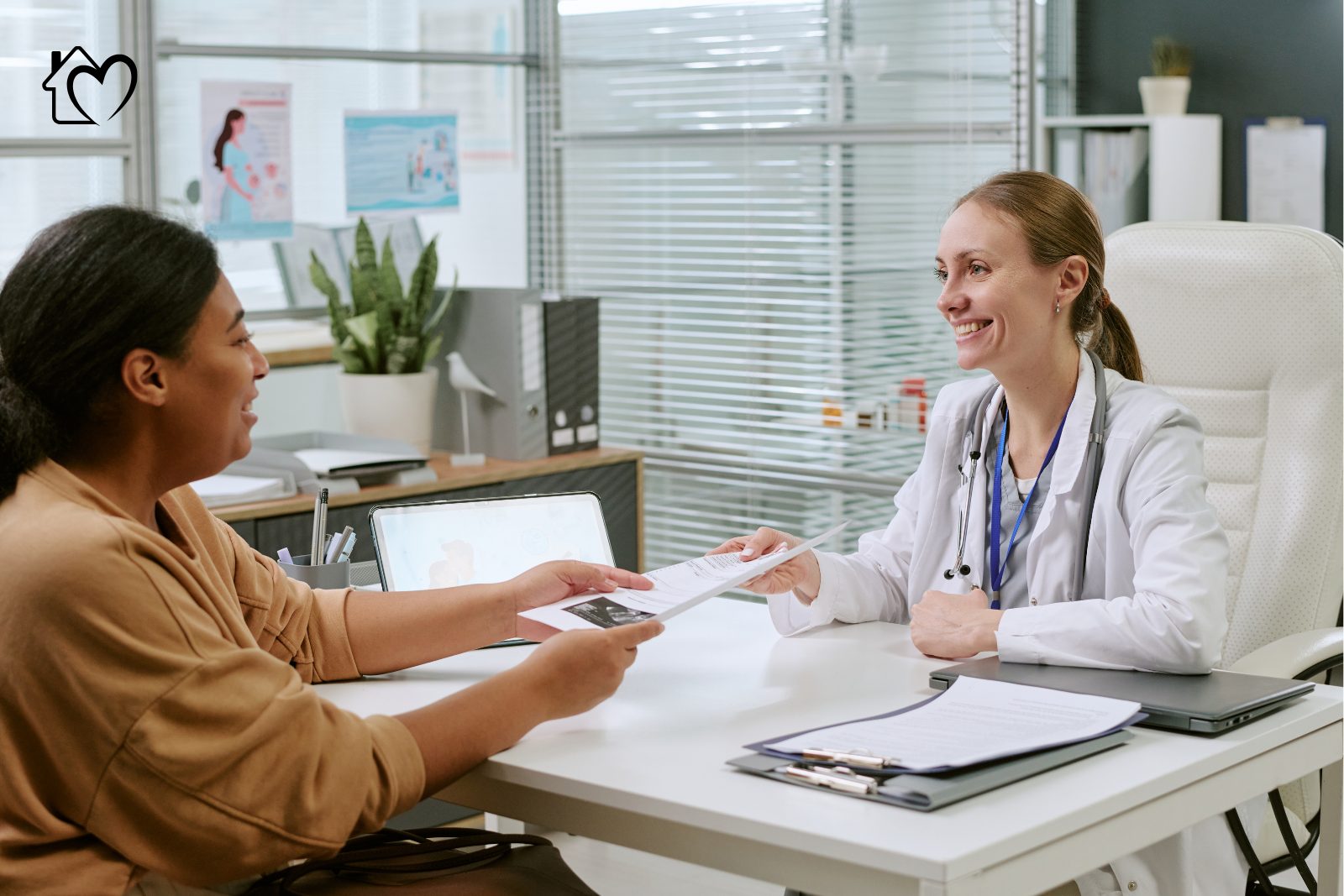A healthcare professional discussing a referral with an older patient