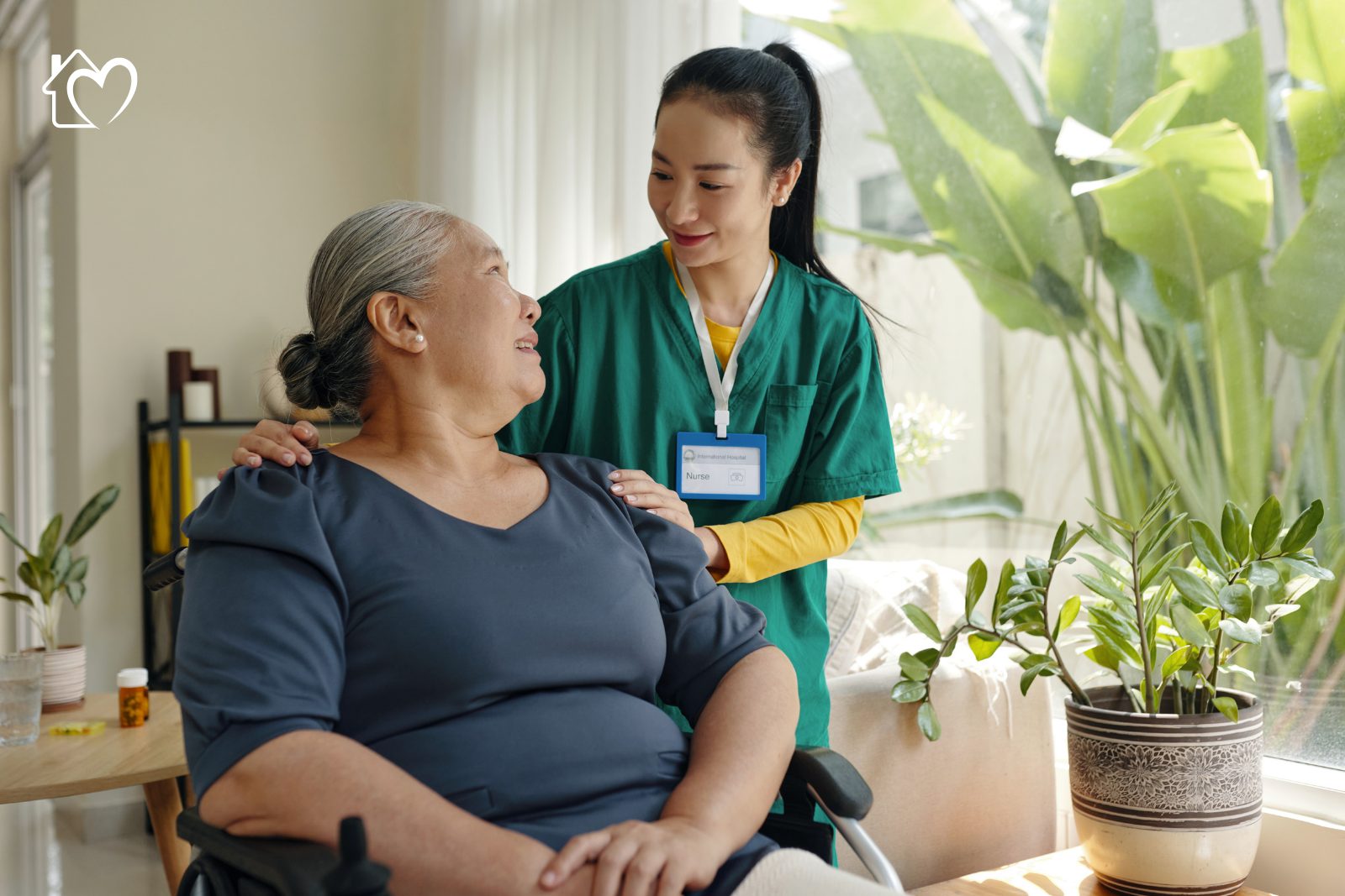 A Bamboo Care support worker and a client talking together at a kitchen table