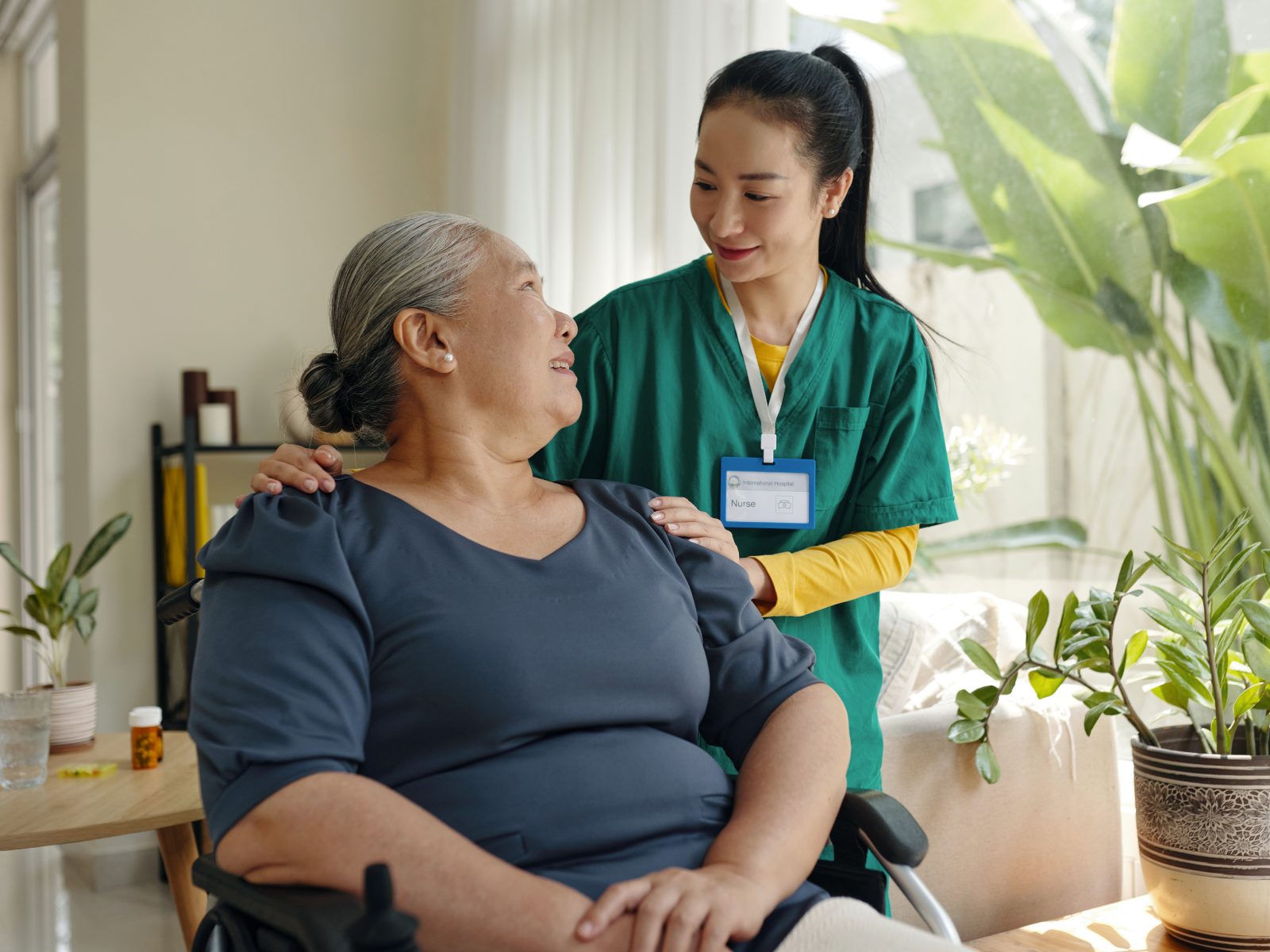 A support worker folding laundry in a client's home