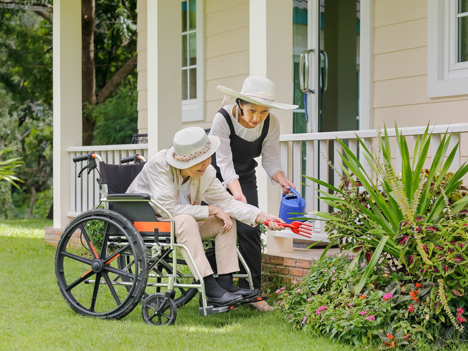 A gardener tidying the front garden of a client's home