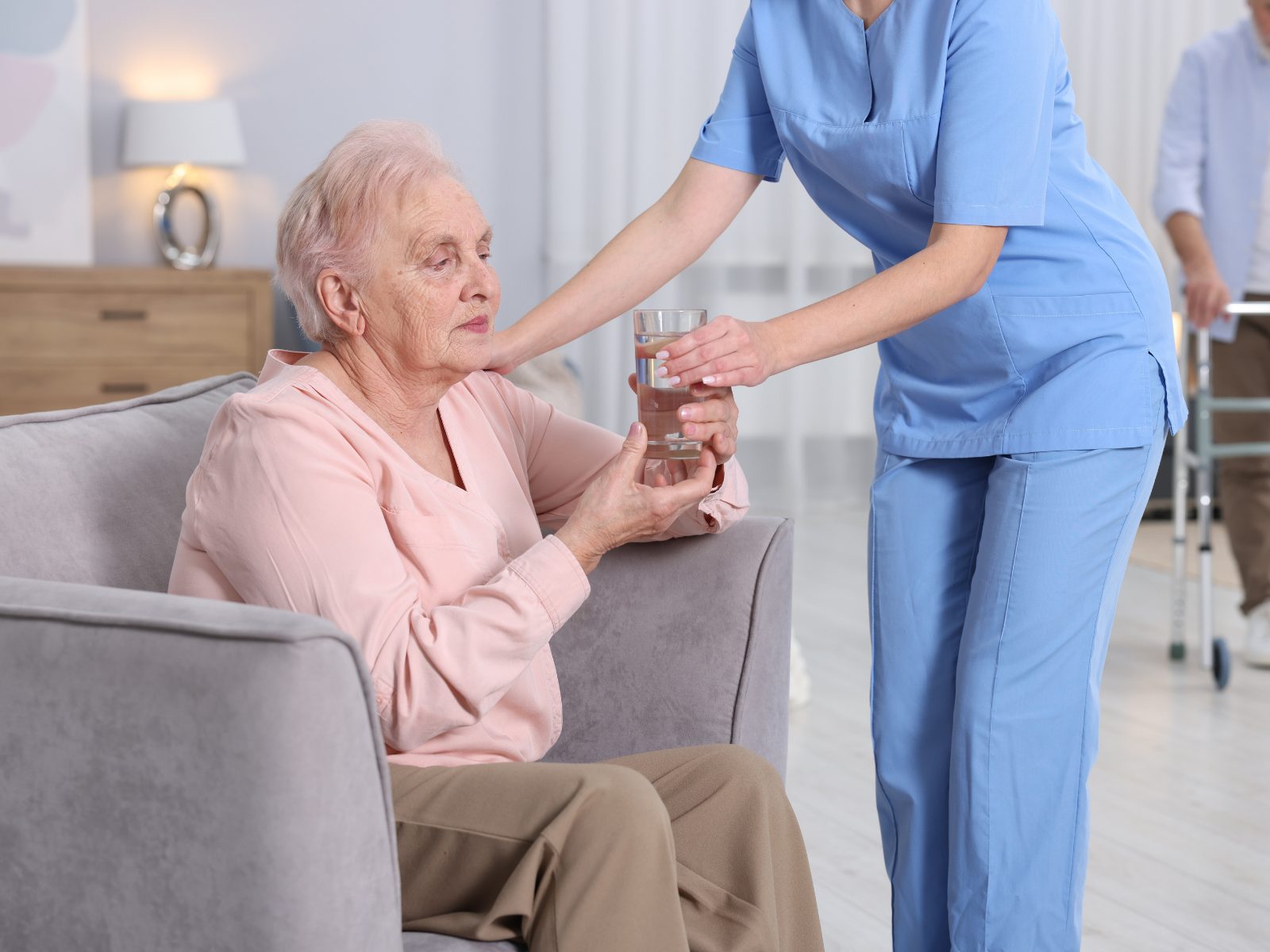 A respite support worker sitting and talking with a client